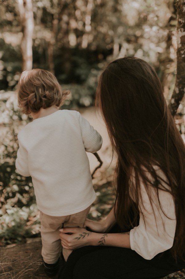 A mother holding her toddler's hand while walking together